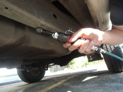 a close up of a person working on a vehicle