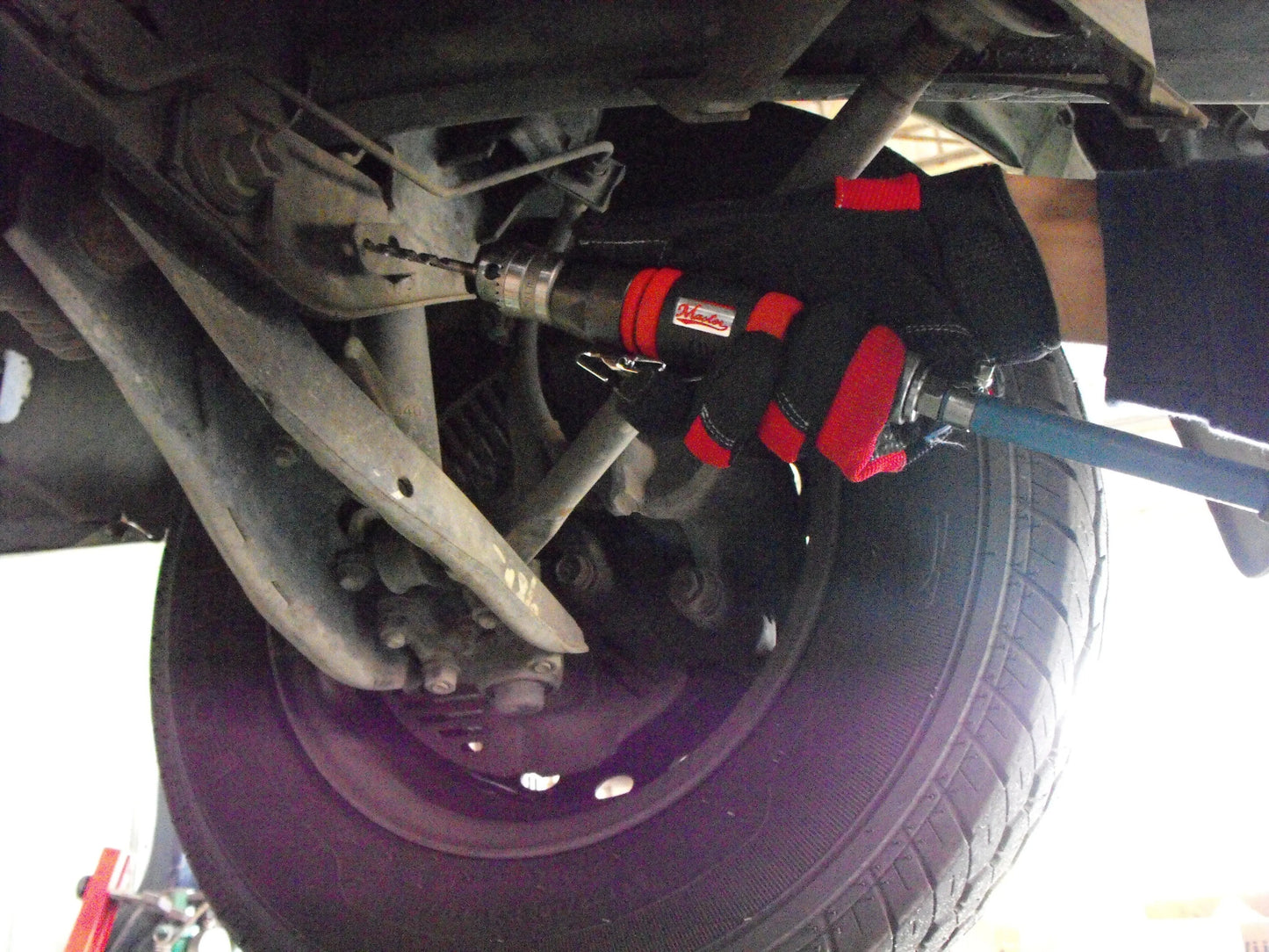 a close up of a tire with a wrench